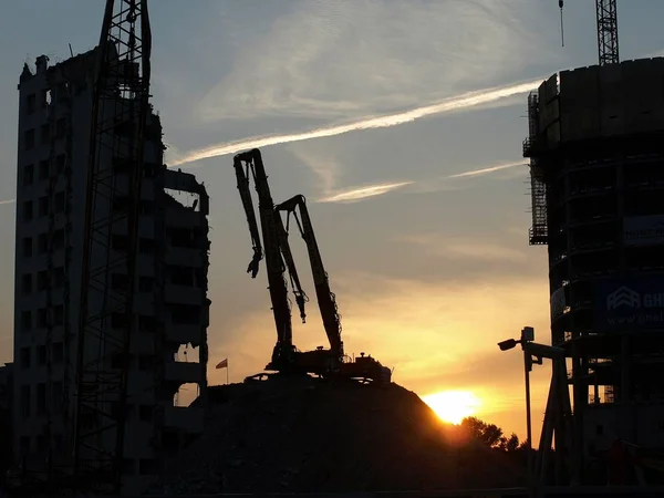Excavation work. Excavator at construction site with sunset