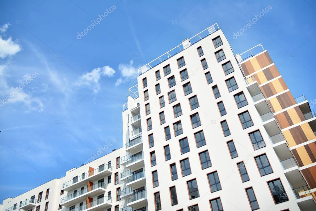 Multistory new modern apartment building. Stylish living block of flats.