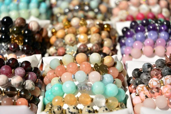Women's colorful stone bracelets handmade. Colourful beads bracelets, isolated on a white background