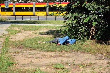 Bilinçsiz sarhoş adam parkta yatıyor