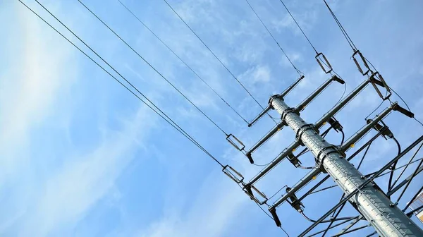 High voltage transmission tower or power tower (electricity pylon) and electrical distribution substation