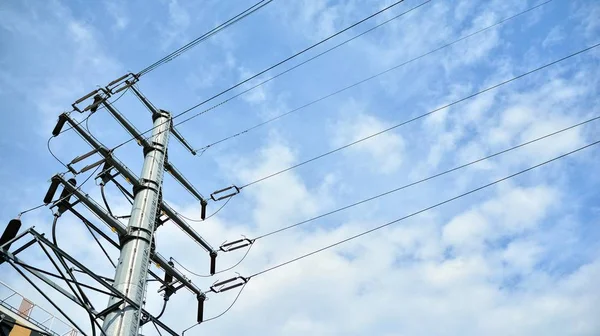 High voltage transmission tower or power tower (electricity pylon) and electrical distribution substation