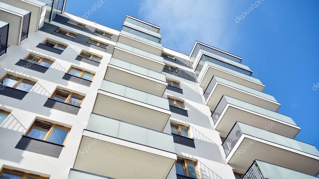 Multistory new modern apartment building. Stylish living block of flats.