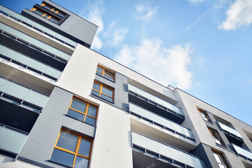 Modern apartment buildings on a sunny day with a blue sky. Facade of a modern apartment building