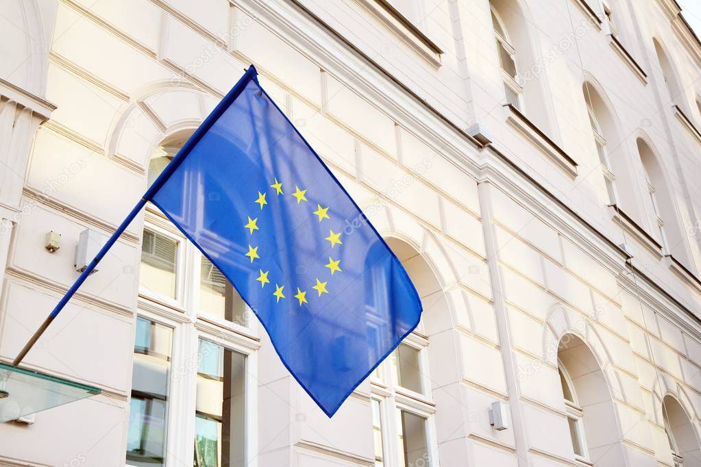 European Union flag waving on a historic building