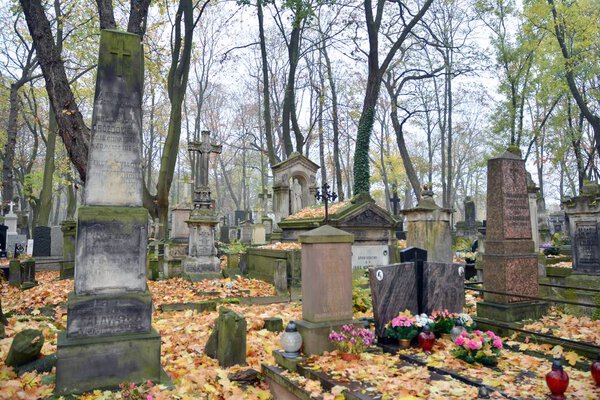 Warsaw, Poland. 24 October 2019. Old Powazki is historic cemetery in Wola District of Warsaw city. Tombstones and trees at the old cemetery.
