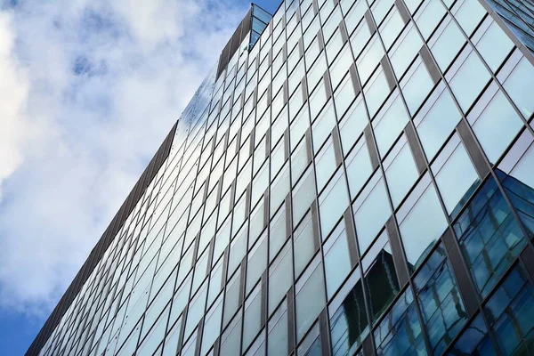 Facade texture of a glass mirrored office building. Fragment of the facade. Modern architecture of the office building.