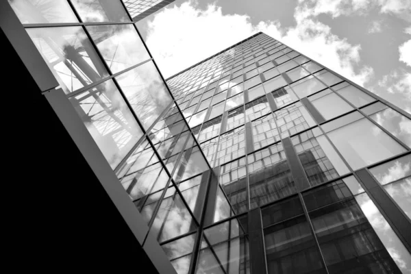 Urban geometry, looking up to glass building. Modern architecture, glass and steel. Abstract modern architecture design with high contrast black and white tone.