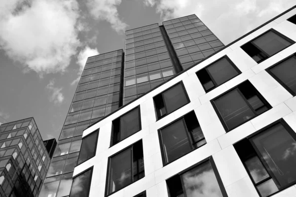 Urban geometry, looking up to glass building. Modern architecture, glass and steel. Abstract modern architecture design with high contrast black and white tone.