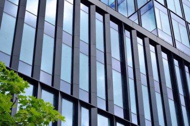 Cam aynalı ofis binasının ön dokusu. Ön cephenin bir parçası. Ofis binasının modern mimarisi.