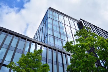 Cam aynalı ofis binasının ön dokusu. Ön cephenin bir parçası. Ofis binasının modern mimarisi.