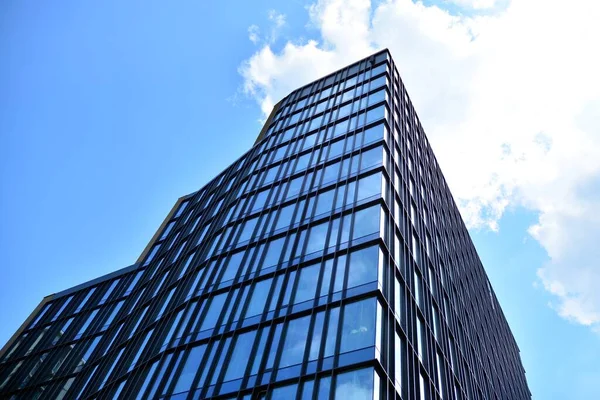 Facade texture of a glass mirrored office building. Fragment of the facade. Modern architecture of the office building.