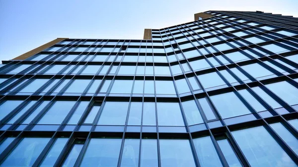 Facade texture of a glass mirrored office building. Fragment of the facade. Modern architecture of the office building.