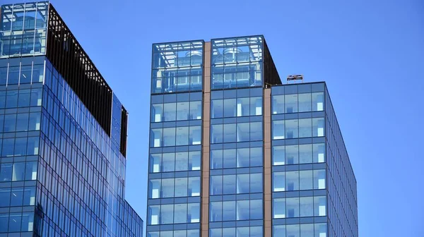 Facade texture of a glass mirrored office building. Fragment of the facade. Modern architecture of the office building.