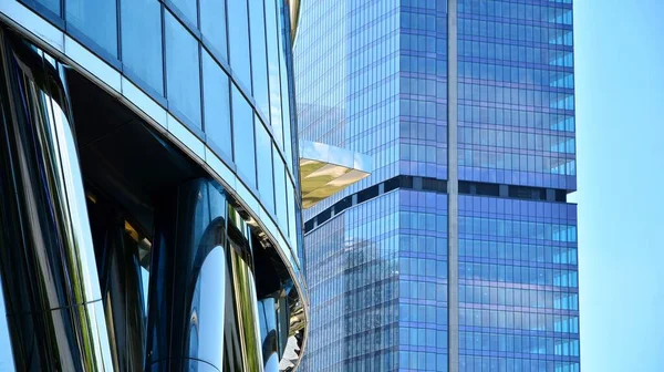 Facade texture of a glass mirrored office building. Fragment of the facade. Modern architecture of the office building.