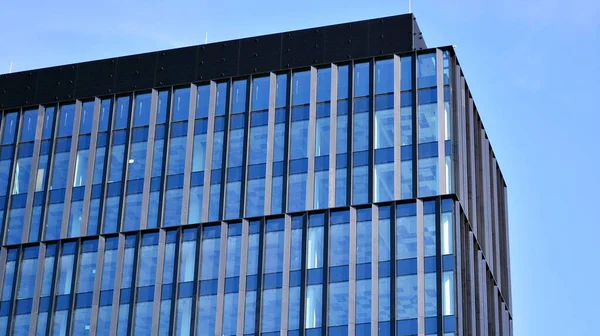 Facade texture of a glass mirrored office building. Fragment of the facade. Modern architecture of the office building.