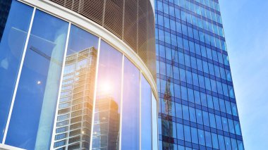 Gökdelenlerin cam siluetinin alt görüntüsü. İş binası. Cam cepheli bir gökdelen. İş bölgesinde modern bir bina. Ekonomi, finans, gelecek kavramları.   