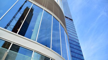Gökdelenlerin cam siluetinin alt görüntüsü. İş binası. Cam cepheli bir gökdelen. İş bölgesinde modern bir bina. Ekonomi, finans, gelecek kavramları.   