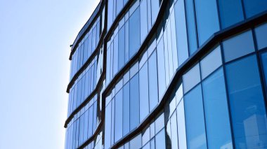 Modern ofis binasının cam perde duvarı. Gökyüzü arka planında modern ofis binası.