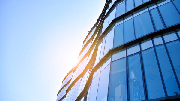 Glass curtain wall of modern office building. Modern office building on a clear sky background.