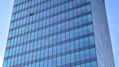 Cam aynalı ofis binasının ön dokusu. Ön cephenin bir parçası. Ofis binasının modern mimarisi.