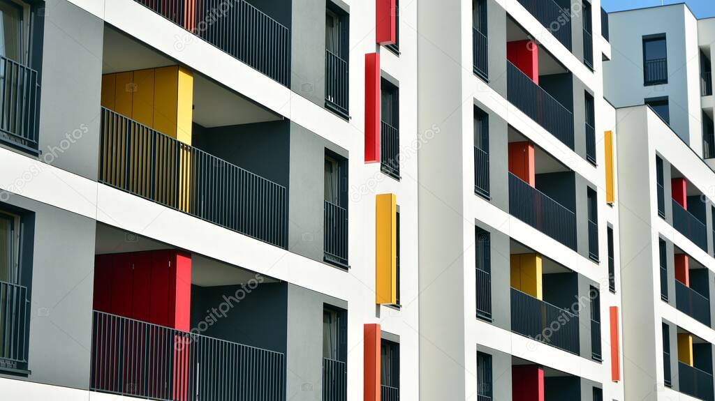 Contemporary residential building exterior in the daylight. Modern apartment buildings on a sunny day with a blue sky. Facade of a modern apartment building