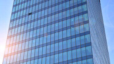 Ofis binası, mavi cam duvar ve güneş yansımalarının detayları..