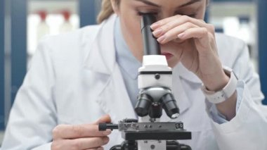 kadın bilim adamı bu durumda Beyaz önlük laboratuvar mikroskop aramak