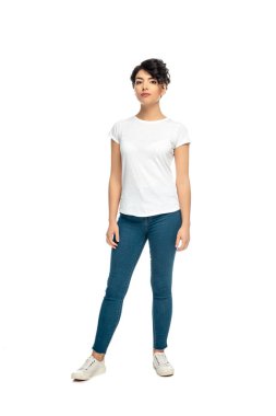 attractive latin brunette woman standing in blue jeans and white t-shirt isolated on white  clipart