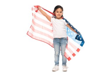 happy latin kid in denim jeans standing with american flag isolated on white  clipart