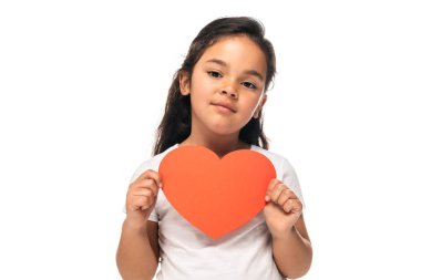 cheerful latin kid holding red heart-shape carton isolated on white  clipart