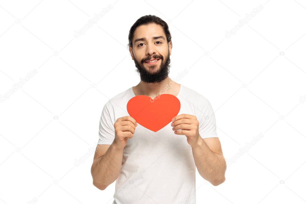 happy latin man holding red heart-shape carton isolated on white 
