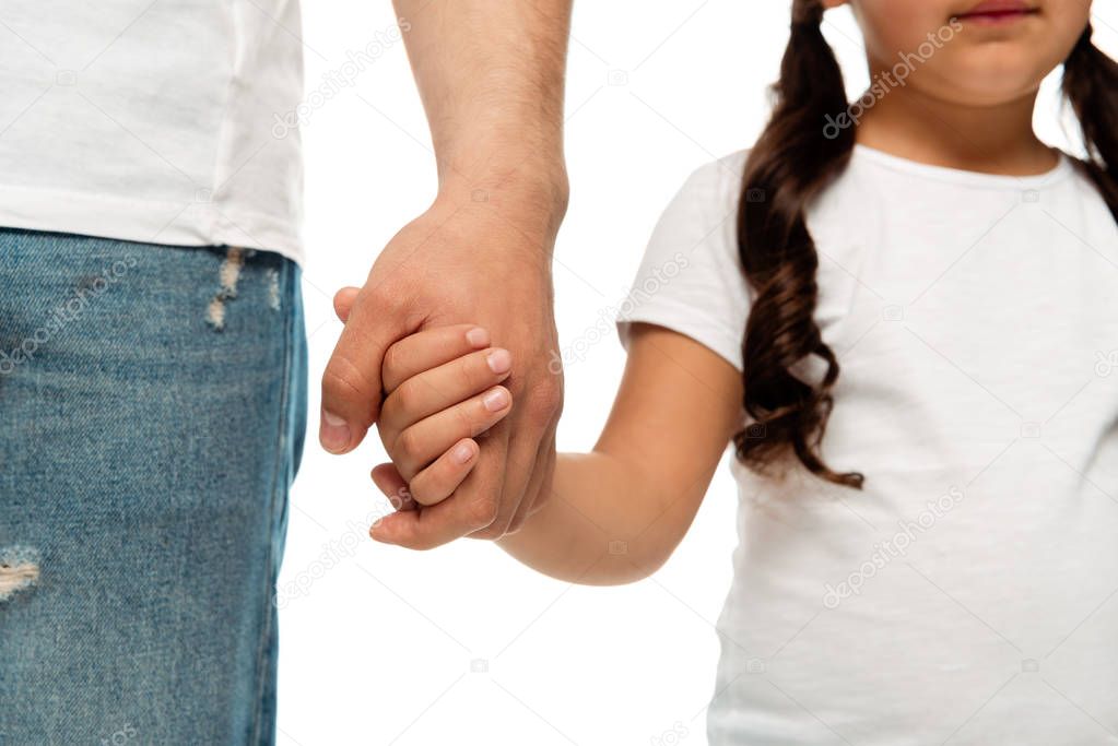cropped view of father and kid holding hands isolated on white 
