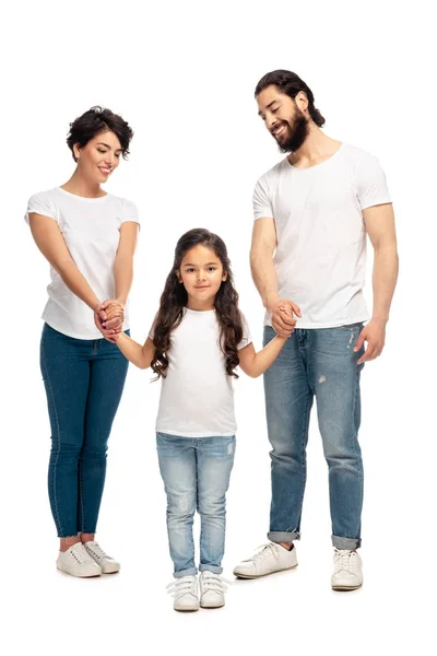 Happy latin parents holding hands with cute daughter while standing isolated on white — Stock Photo