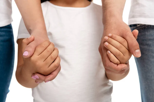 Cropped view of parents holding hands with daughter isolated on white — Stock Photo