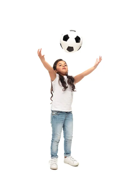 Cheerful latin kid playing with soccer ball isolated on white — Stock Photo