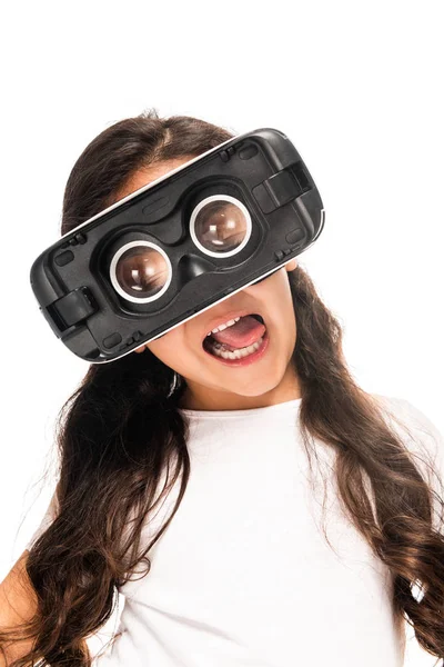 Cute latin kid showing tongue while wearing virtual reality headset isolated on white — Stock Photo
