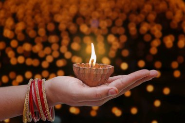 Indian Festival diwali , Lamp in hand clipart