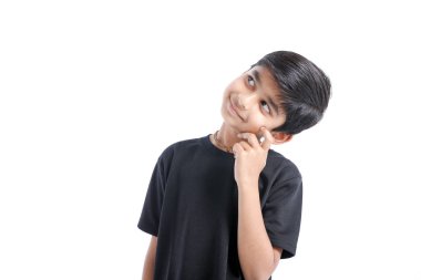 Cute Indian boy thinking idea and looking at up, isolated on white background 