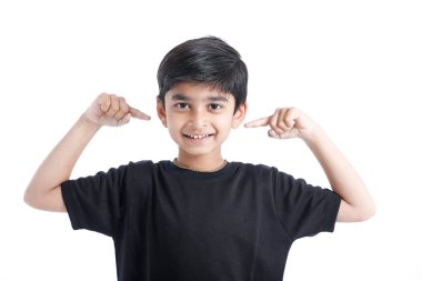 Indian little boy over isolated white background , covering ears with hands.