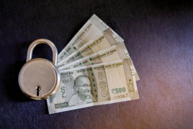 Indian money with lock , money protection concept