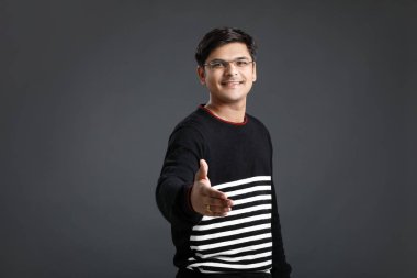 young indian man making a deal over 