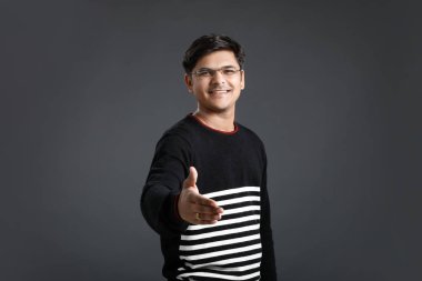 young indian man making a deal over 