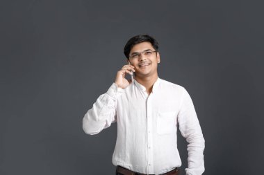Young Indian talking on mobile phone