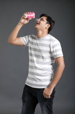 Young indian man drinking a water