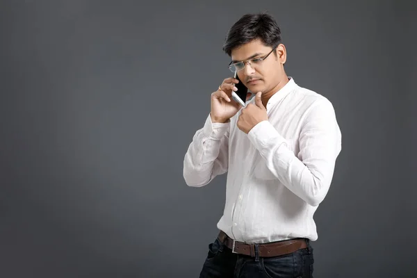 Young Indian Talking Mobile Phone — Stockfoto