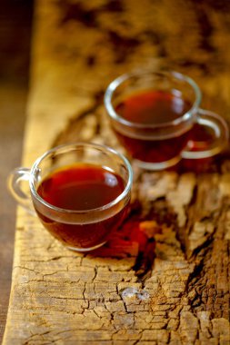 Black tea in cup with lemon