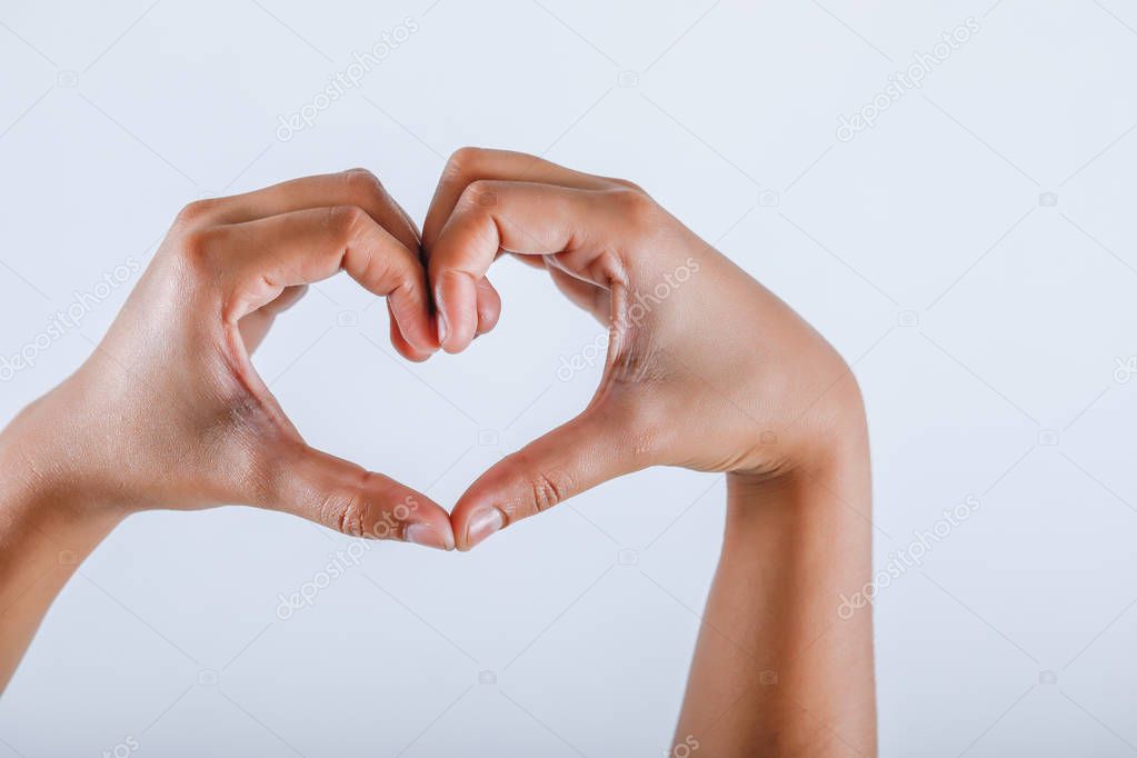 Human hand showing heart shape with hand