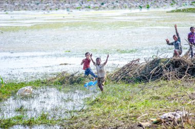 Jalgaon, India - January 10, 2016: Rural Indian Child Playing in river