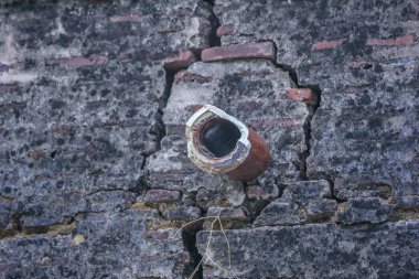 old downpipe in stone wall